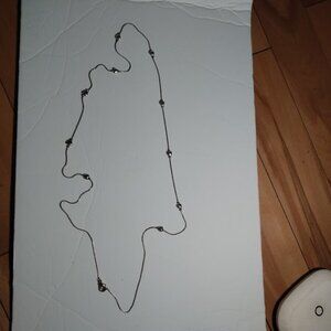 Silver tone chain necklace with hearts.